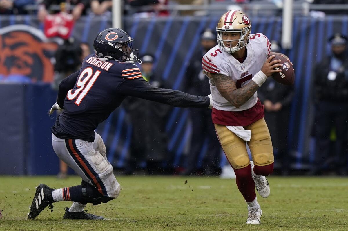 San Francisco 49ers' Trey Lance tries to get past San Francisco 49ers' Arik Armstead during the second half of an NFL football game Sunday, Sept. 11, 2022, in Chicago. (AP Photo/Nam Y. Huh)