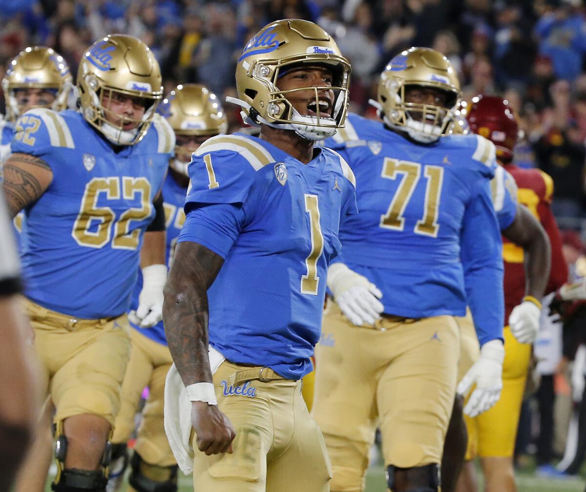 UCLA quarterback Dorian Thompson-Robinson celebrates after scoring a touchdown against USC in the first half.