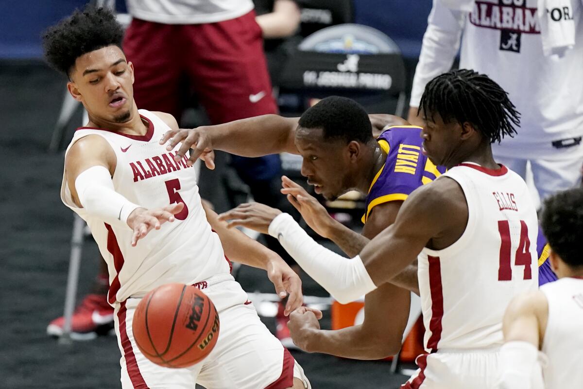 Alabama's Jaden Shackelford battles for the ball with LSU's Aundre Hyatt.