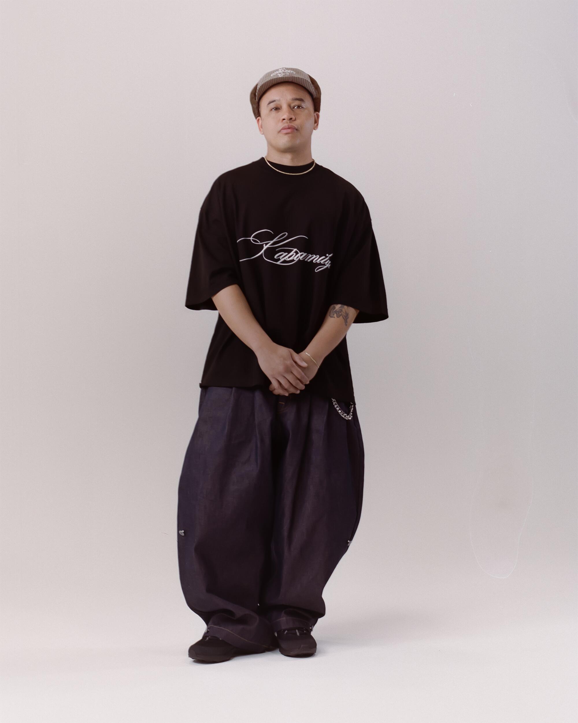 Miles wears FAMILY by Coen Clemente Moreno Oversized tee, Art Community Triptych Japanese Denim pants and Pilot Brim hat