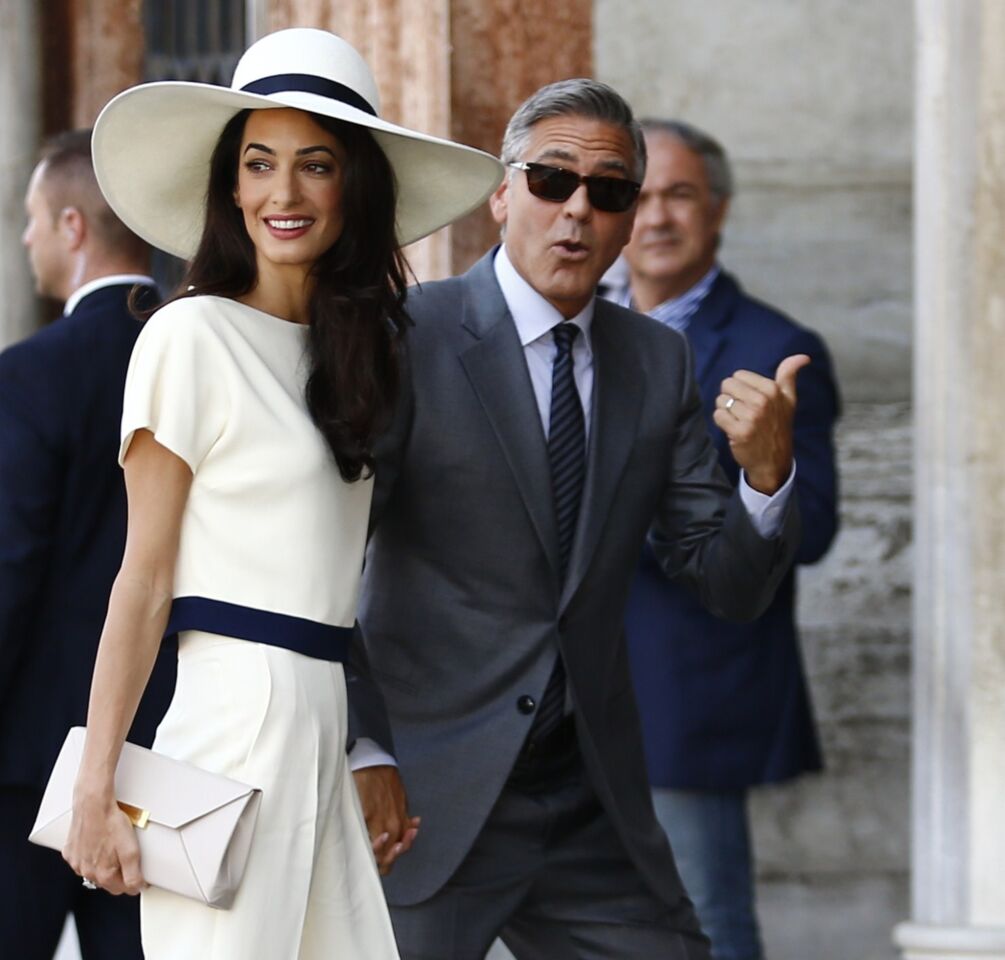 "I've got to go in," George Clooney seems to be saying as he and wife Amal Alamuddin arrive at Ca'Farsetti palace in Venice, Italy, for the civil ceremony part of their wedding weekend.