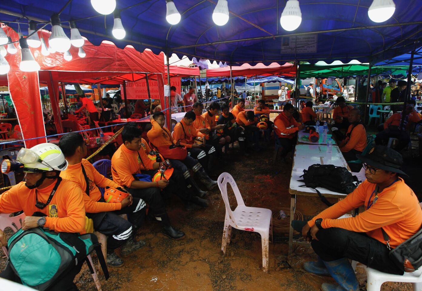 Thai civil defense volunteers prepare to join the rescue operation for the 12 trapped boys and their coach Sunday at Tham Luang cave.