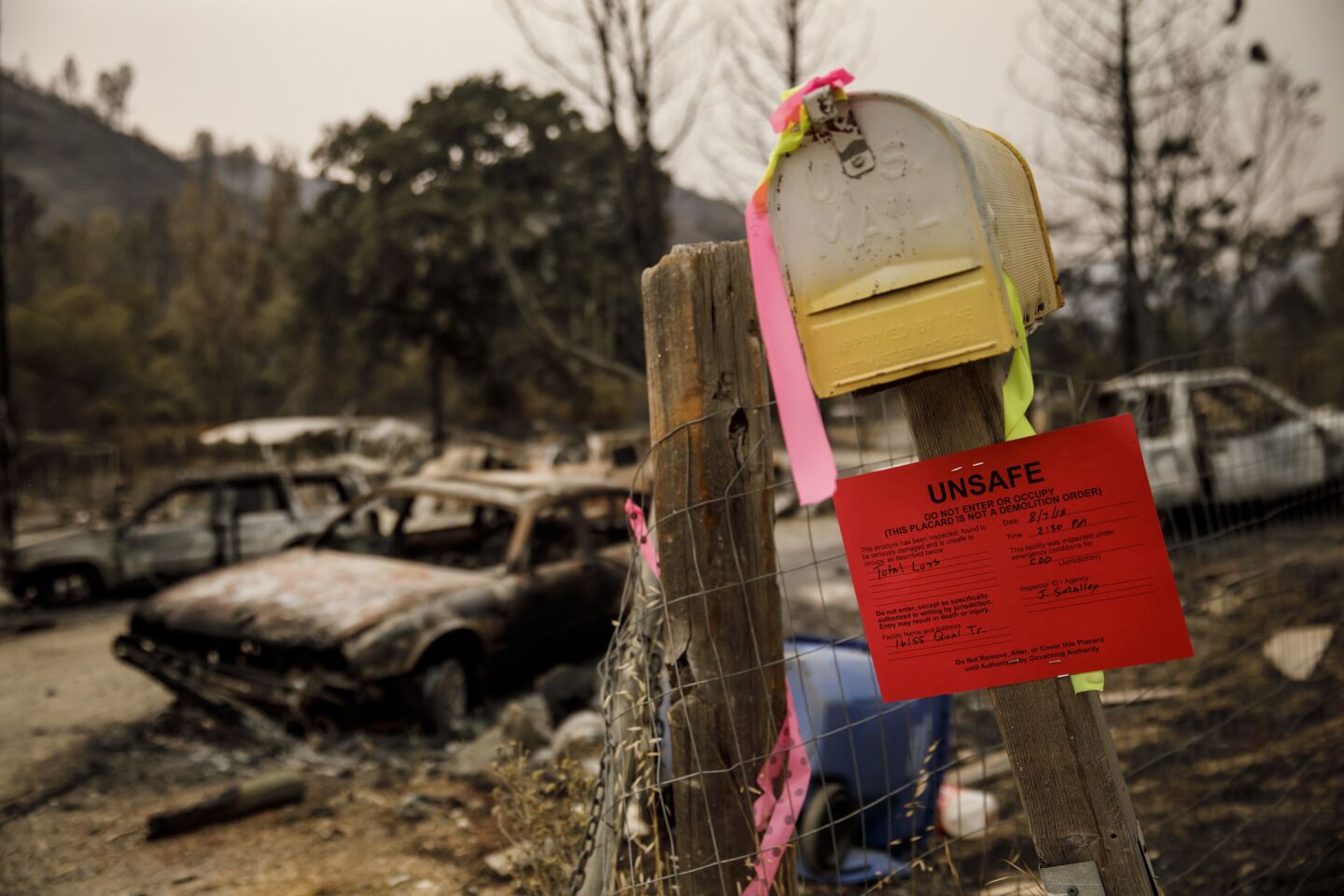 A sign warns people to stay out of a burned area in Clearlake Oaks, Calif.