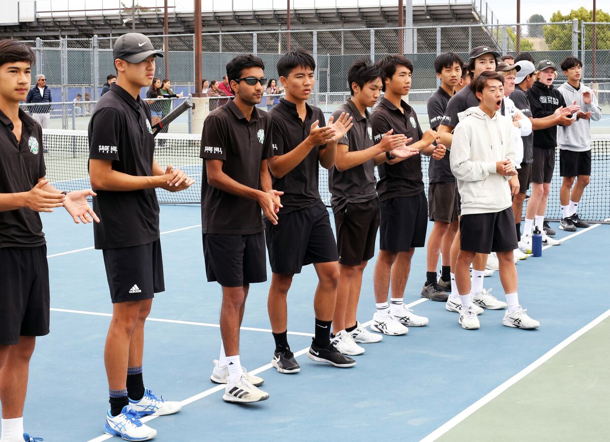 The Sage Hill School boys' tennis team cheers on teammate William Chen during Wednesday's match at Ayala.