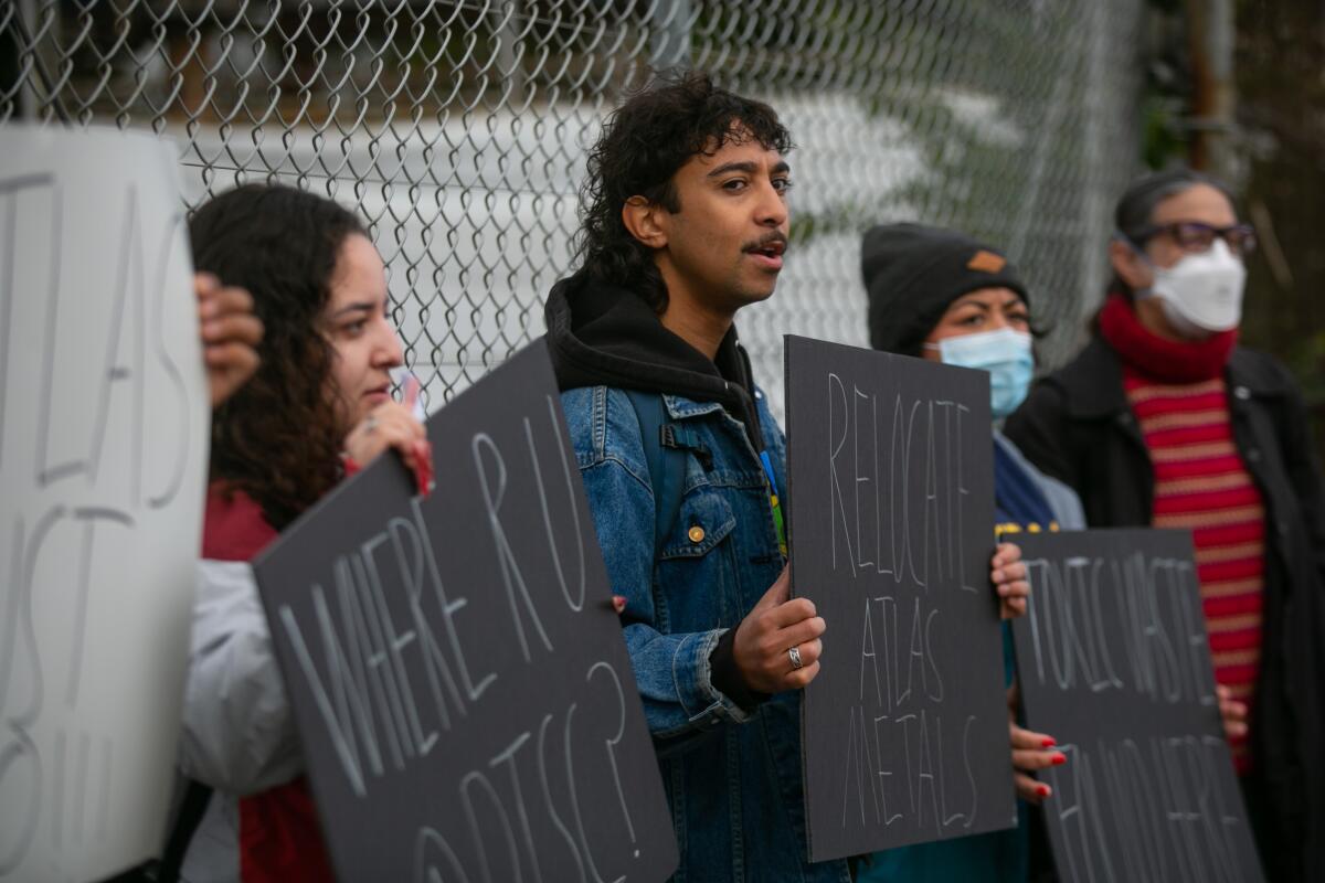 Elijah Catalan, 24, protest along with students from Jordan High School in front of Atlas Iron and Metal Company