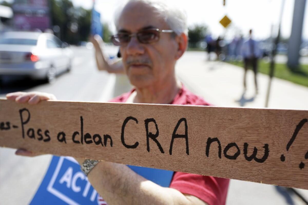 Outside of a Department of Veterans Affairs regional administrative center in Philadelphia on Wednesday, David Schogel demonstrates with others in support of the 2010 federal healthcare law and calling for an end to the government shutdown.