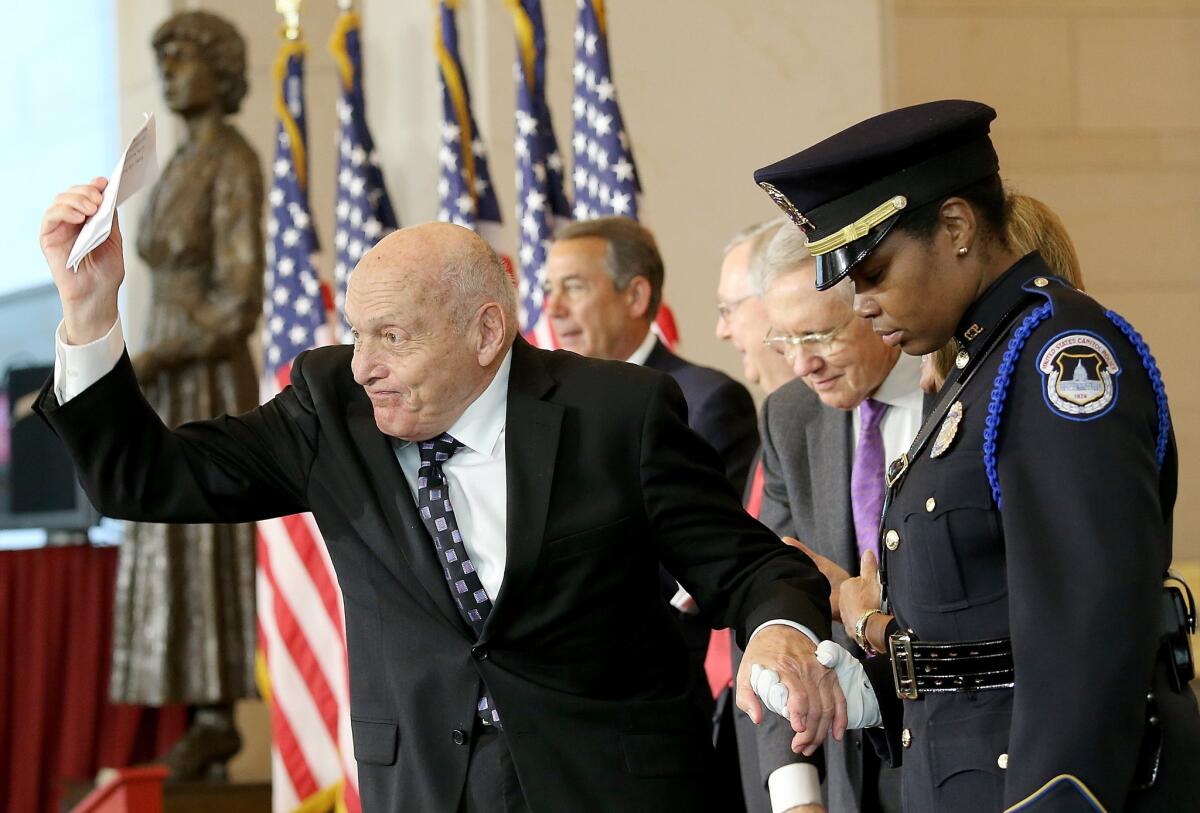 Harry Ettlinger, a subject of the "Monuments Men" book and movie, celebrates after receiving the Congressional Gold Medal on Thursday at the Capitol in Washington. The event honored the men and women who protected historical sites and recovered cultural artifacts during World War II.