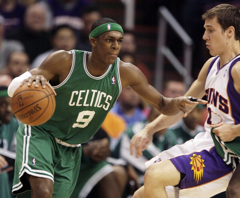 Boston Celtics guard Rajon Rondo, left, dribbles around Phoenix Suns guard Goran Dragic, right, of Slovenia, in the first quarter of an NBA basketball game Sunday, Feb 22, 2009, in Phoenix. Rondo was the game's high-scorer with 32 points as the Celtics won 128-108.
