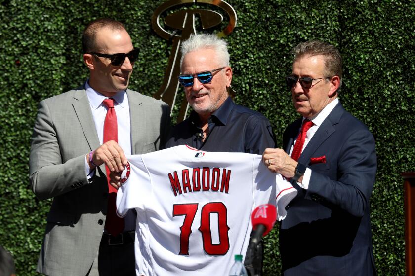 ANAHEIM, CALIF. -- THURSDAY, OCTOBER 24, 2019: The Los Angeles Angels of Anaheim introduce Joe Maddon, center, flanked by General Manager Billy Eppler, left, and Owner Arte Moreno, as latest manager of the team at a press conference held at Angel Stadium in Anaheim, Calif., on Oct. 24, 2019. (Gary Coronado / Los Angeles Times)
