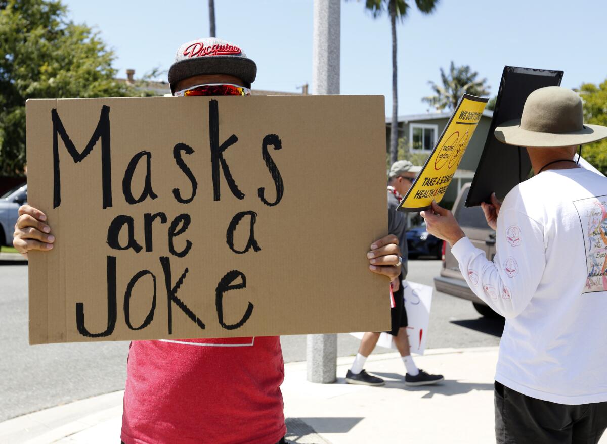 An anti-mask protester demonstrates in Costa Mesa on Saturday, Aug. 15, 2020. 
