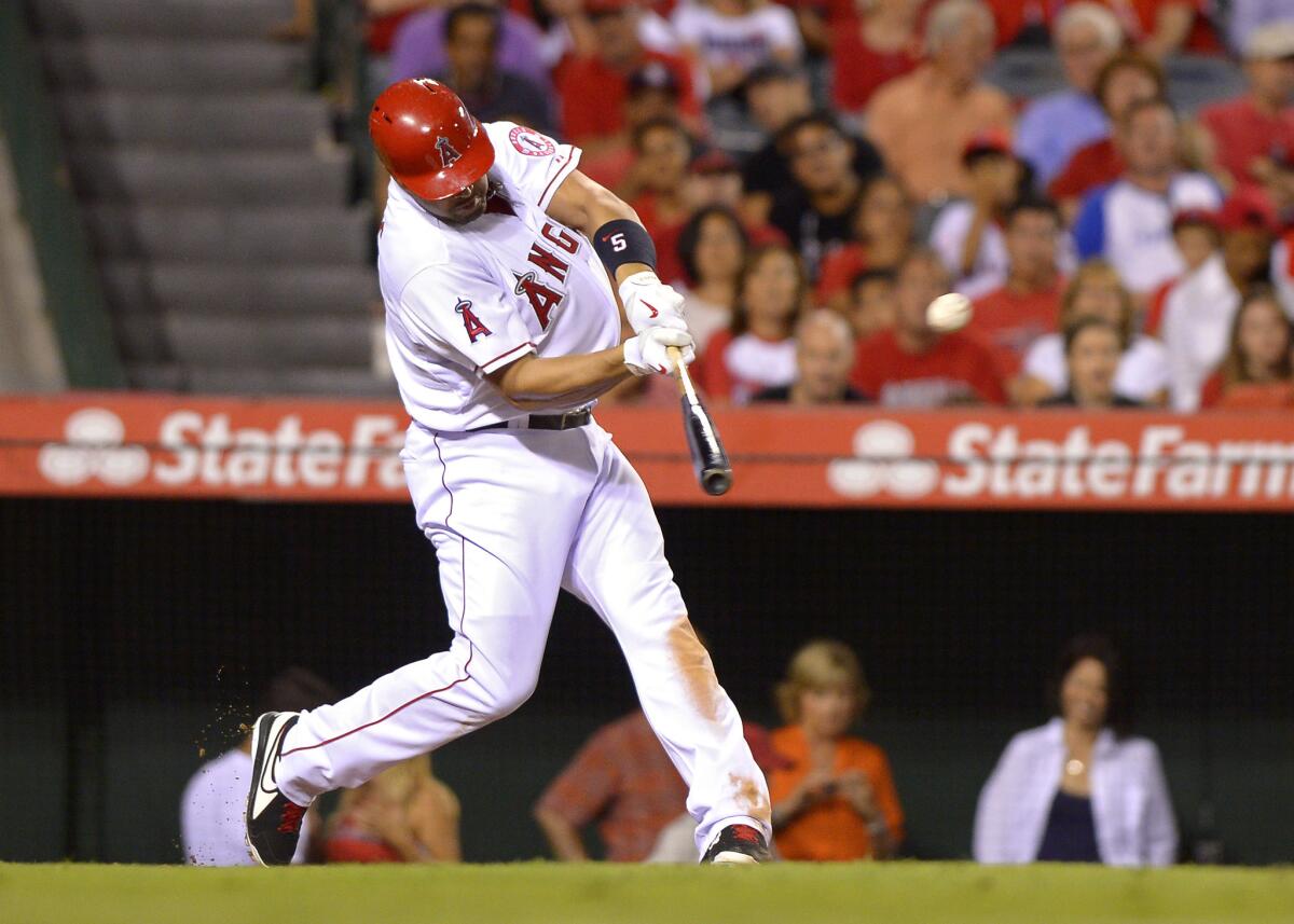 Los Angeles Angels' Albert Pujols hits a two-run home run during the fifth inning Saturday against Texas.