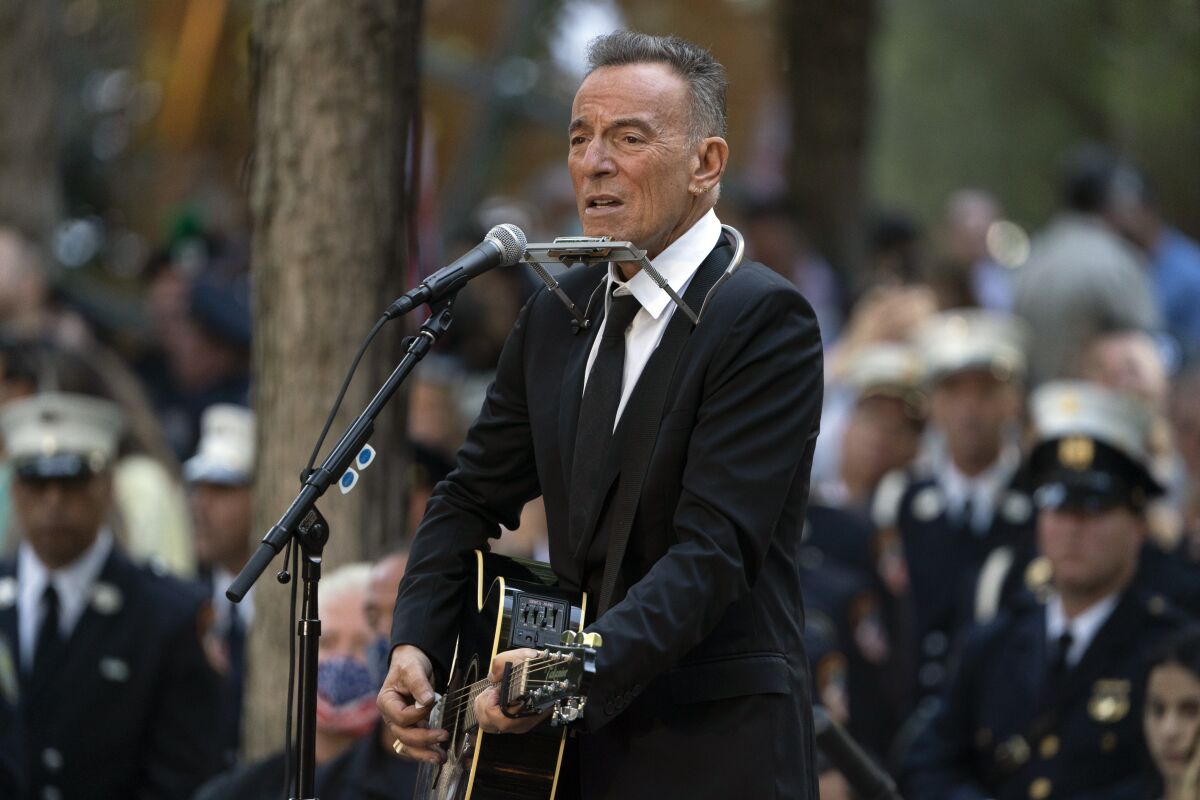 FILE - In this Saturday, Sept. 11, 2021, file photo, Bruce Springsteen performs during ceremonies to commemorate the 20th anniversary of the 9/11 terrorist attacks, at the National September 11 Memorial & Museum in New York. Springsteen’s most memorable artifacts including his favorite Fender guitar and stage outfits will be on display in a traveling interactive exhibit. The Grammy Museum announced Tuesday, Sept. 14, 2021, that Bruce Springsteen Live! will open at the Grammy Museum Experience in the Prudential Center in Newark, New Jersey, on Oct. 1. (AP Photo/John Minchillo, File)