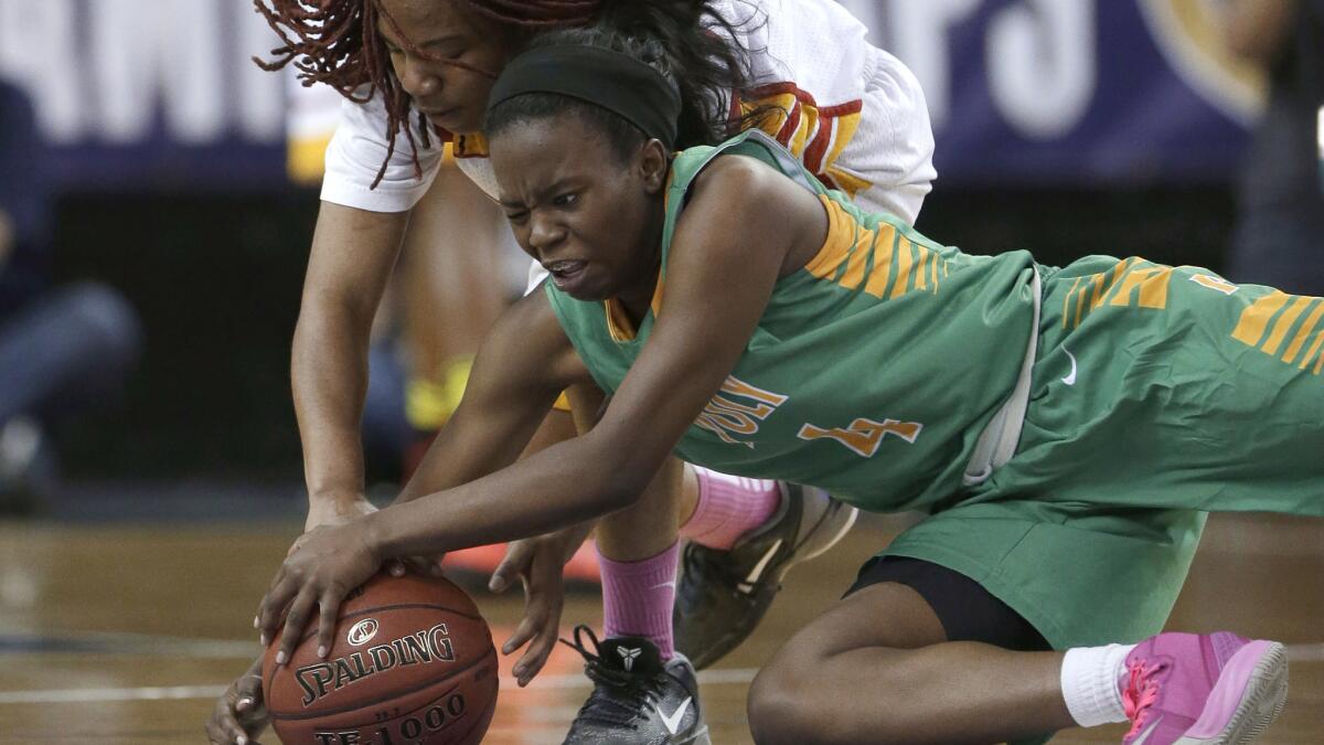Long Beach Poly's Tania Lamb, right, and Berkeley's Breona Eskridge battle for a loose ball during Poly's victory in the CIF state Division I championship game on March 22.