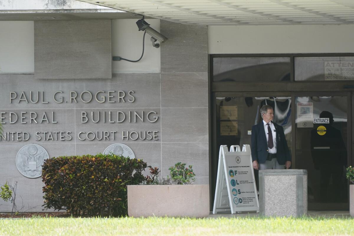 A security guard stands outside the Paul G. Rogers Federal Building and U.S. Courthouse in West Palm Beach, Fla. 