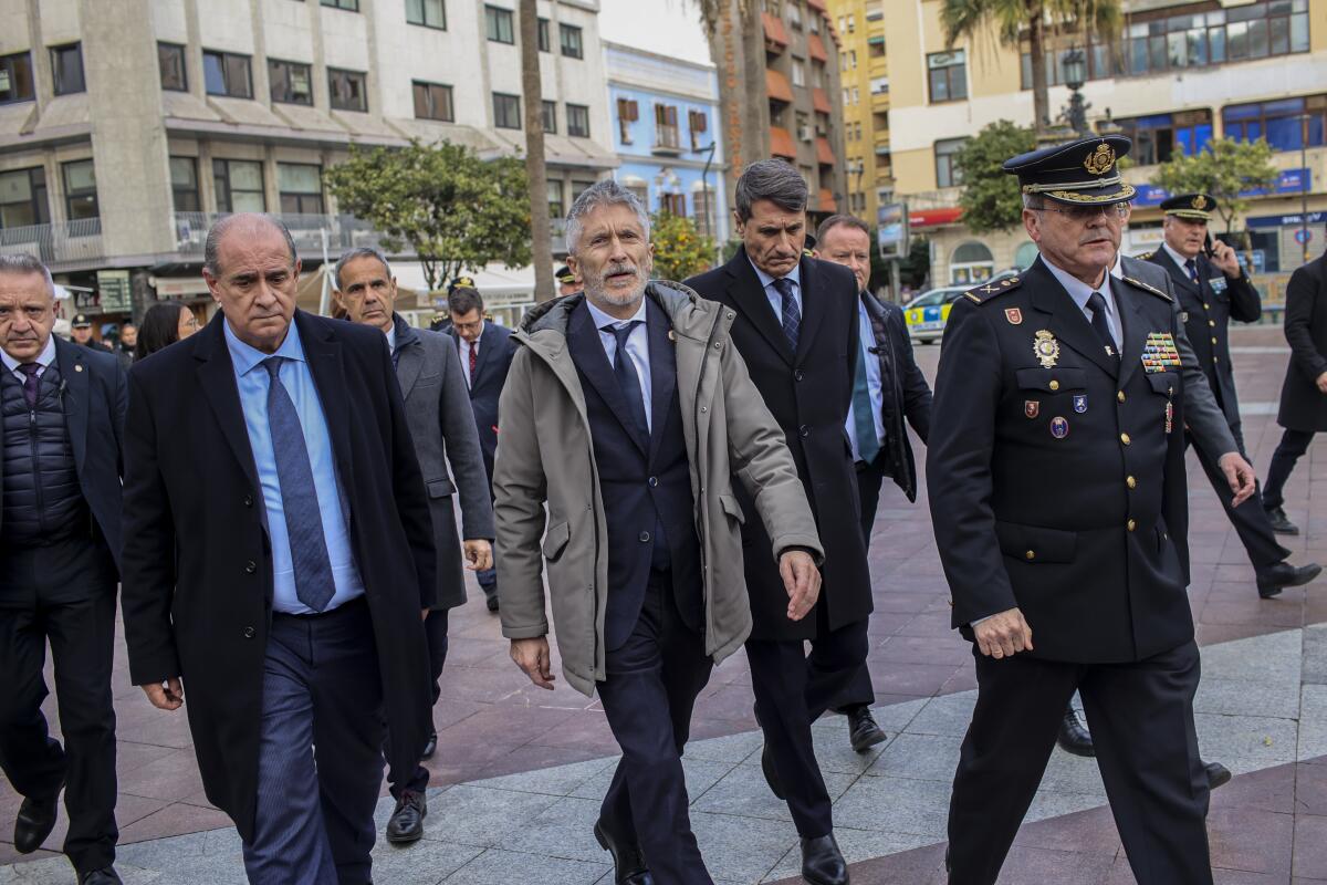 FILE - Interior Minister of Spain Fernando Grande-Marlaska, center, arrives to the church in Algeciras, Spain, on Jan. 26, 2023. Spain's government on Wednesday, Feb. 8, 2023 pledged stronger action against cybercrime, which according to official data accounts for about a fifth of all offenses registered in the country. Interior minister Fernando Grande-Marlaska said police would be given additional staff, funding and resources to address online crime. He said reported cases of cybercrime were up 72% last year. (AP Photo/Juan Carlos Toro)