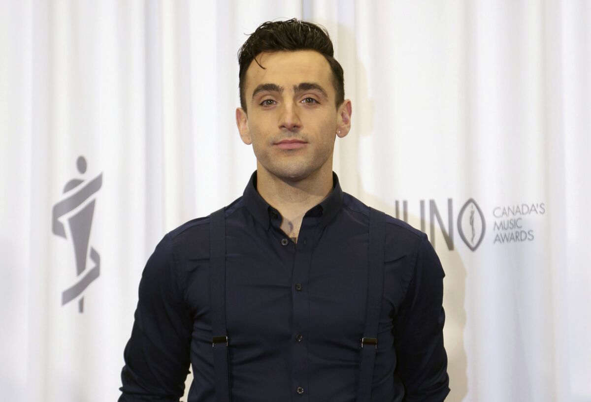 FILE - Jacob Hoggard, frontman for the Canadian band Hedley, poses backstage following the 2015 Juno Awards in Hamilton, Ontario, on Sunday, March 15, 2015. Hoggard was convicted Sunday, June 5, 2022, of sexual assault causing bodily harm to an Ottawa woman but acquitted of the same charge involving a teenage fan. (Peter Power/The Canadian Press via AP, File)