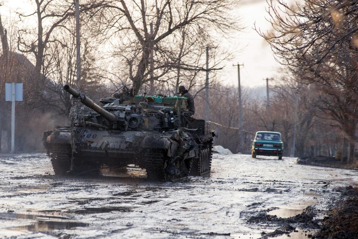 An armored vehicle pulls a Ukrainian tank in the village of Horlivka in the Donetsk region, after it was damaged in combat between Ukrainian forces and pro-Russia separatists on Feb. 4.