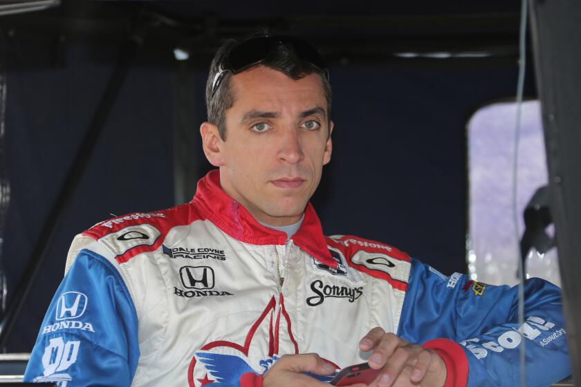 Justin Wilson waits to qualify at the IndyCar Detroit Grand Prix in June 2014.