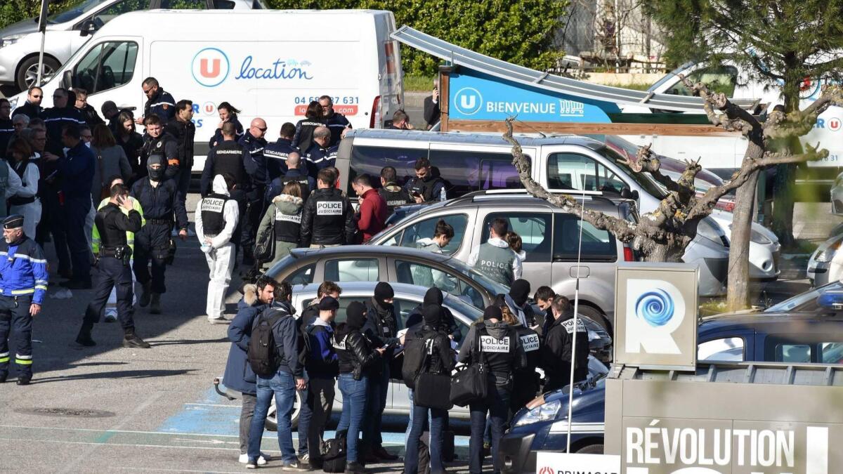The scene outside a supermarket in Trebes, France, where a gunman was killed after taking hostages.