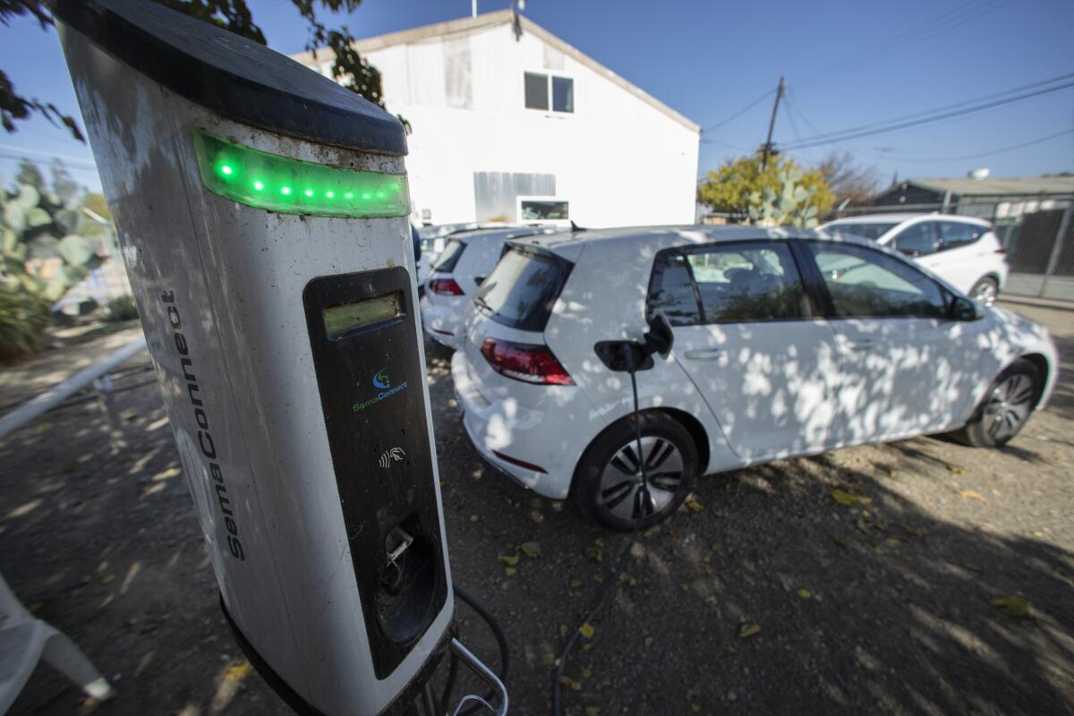 A car that is part of an electric car ride-sharing initiative charges at a station in Huron in Fresno County.