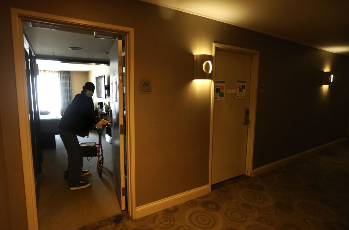 David William, 63, returns to his room at a Project Roomkey hotel.