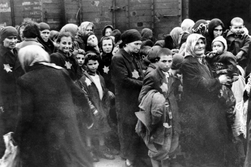 Prisoners at the Nazi death camp in Auschwitz, Poland, in a 1944 photo. An 89-year-old former guard at the camp died in Philadelphia on Tuesday hours before a judge ordered his extradition to Germany to face war crime charges.