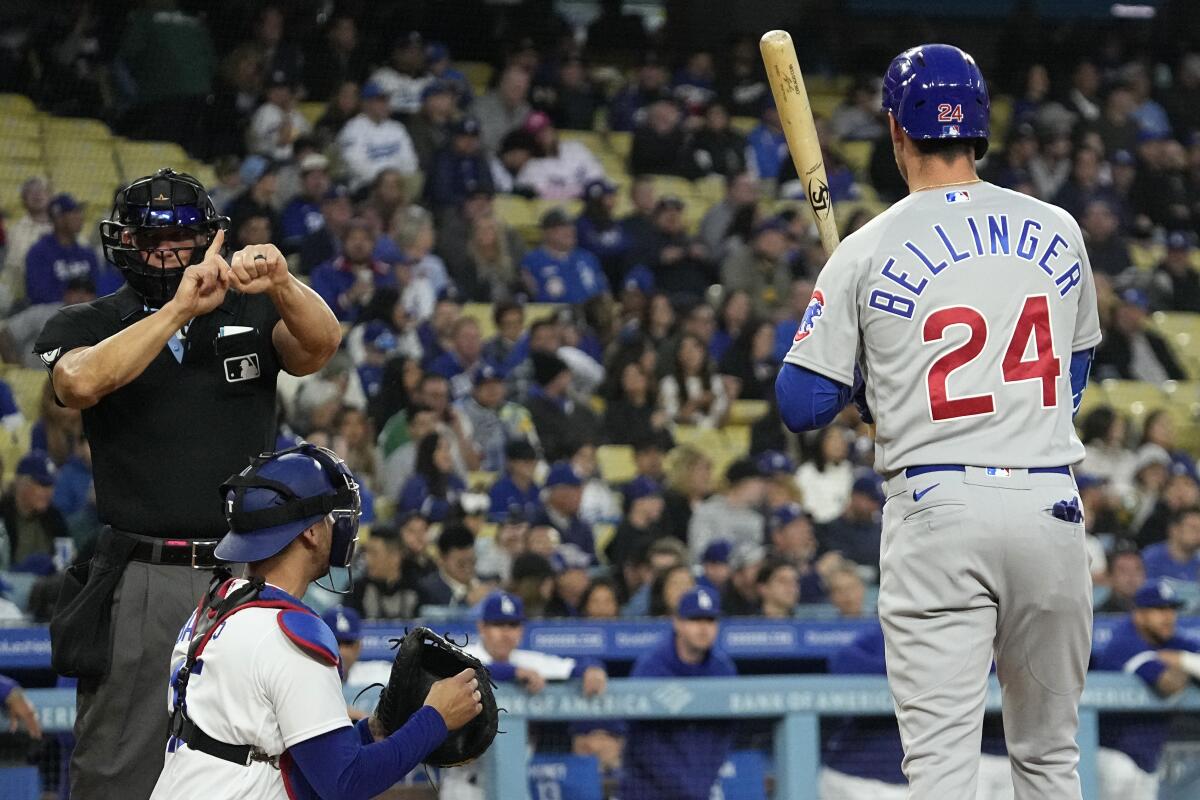 Home plate umpire Jim Wolf calls a strike on Cubs batter Cody Bellinger for a pitch-clock violation.