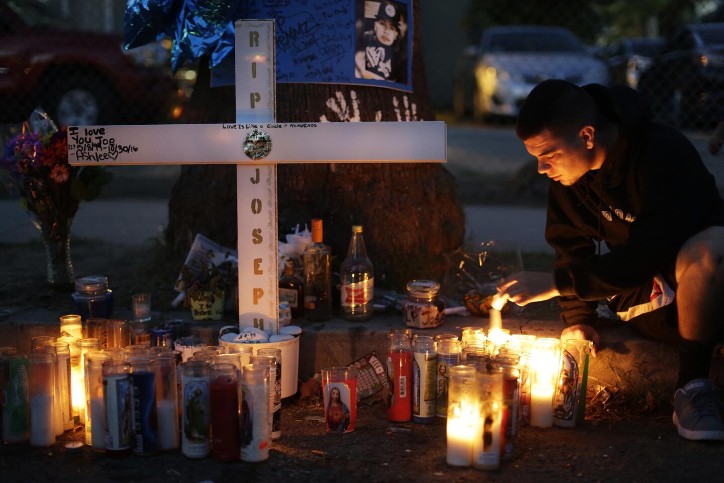 Kyle Rodriguez, 19, lights a candle at a makeshift memorial for his brother Joseph Rodriguez, whose homicide is among 60 murders so far this year in San Bernardino.