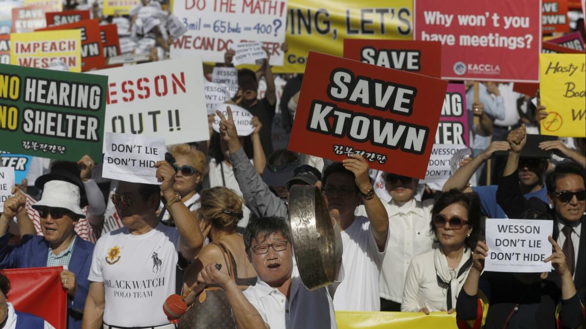 A crowd protests a city plan to set up a homeless shelter on Vermont Avenue in Koreatown on June 3.