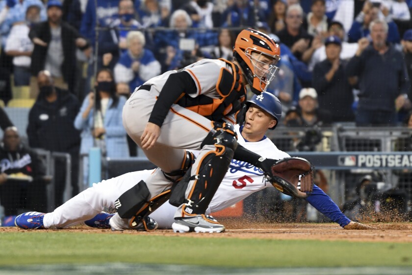 Dodgers' Corey Seager scores past San Francisco Giants catcher Buster Posey on an RBI double by Trea Turner.