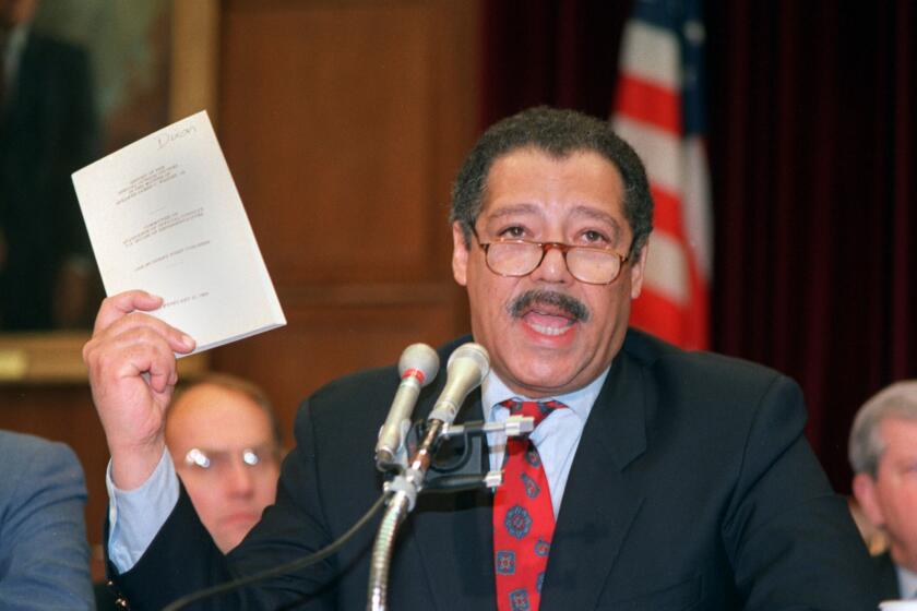 FILE––House Ethics Committee Chairman, Rep. Julian Dixon, D–Calif., holds a report about ethics violations by House Speaker Jim Wright of Texas in this April 17, 1989, file photo taken in Washington. Dixon died Friday, Dec. 8, 2000, in Los Angeles of an apparent heart attack. He was 66. (AP Photo/ Rick Bowmer, File)