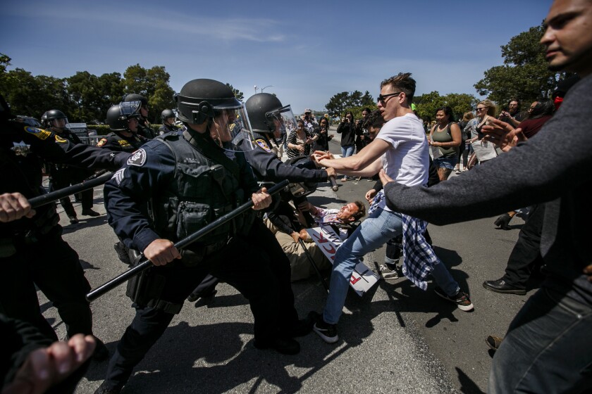 Trump protesters clash with police outside the California Republican Convention in Burlingame, Calif.