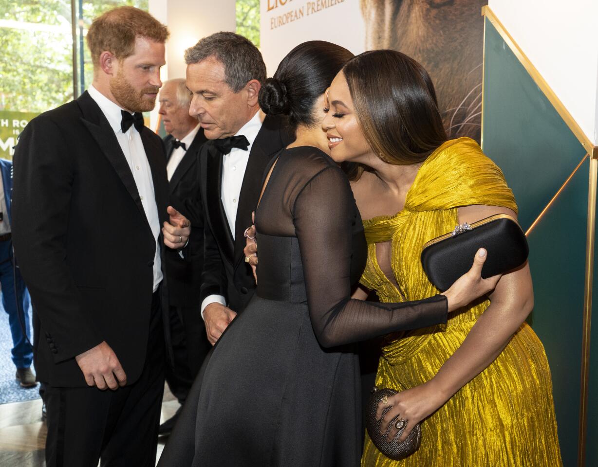 Prince Harry, Duke of Sussex, left, chats with Disney CEO Robert Iger as Meghan, Duchess of Sussex embraces Beyonce Knowles-Carter as they attend the European premiere of Disney's "The Lion King" at Odeon Luxe Leicester Square on July 14, 2019, in London, England.