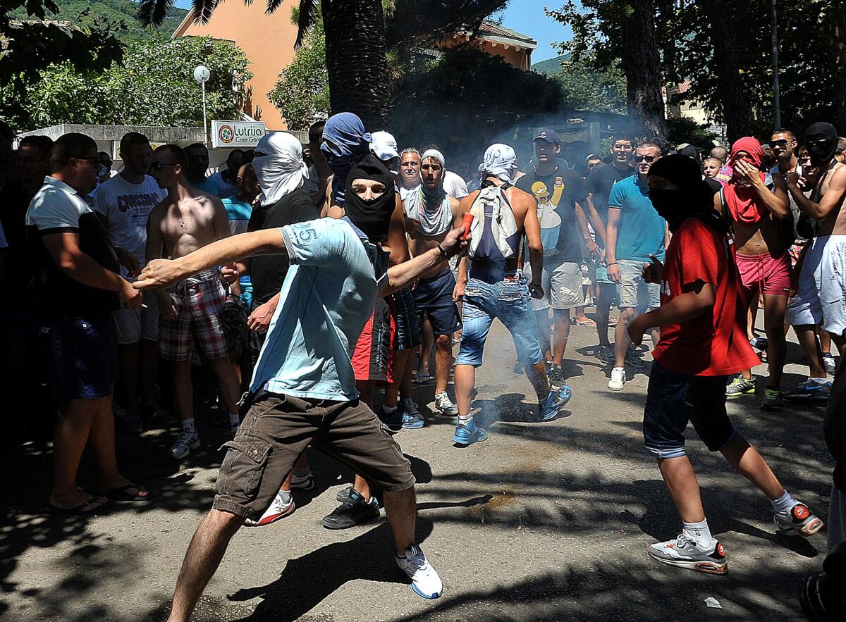 A protester attacks a march by gay rights activists in the Montenegrin coastal resort of Budva. The display of intolerance could harm the former Yugoslav republic's bid to join the European Union.