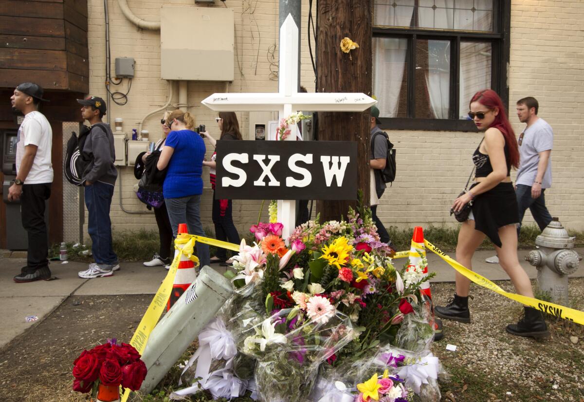 A cross and flowers were placed outside The Mohawk club in Austin, Texas, as a memorial to the people who died in the hit-and-run tragedy at SXSW.