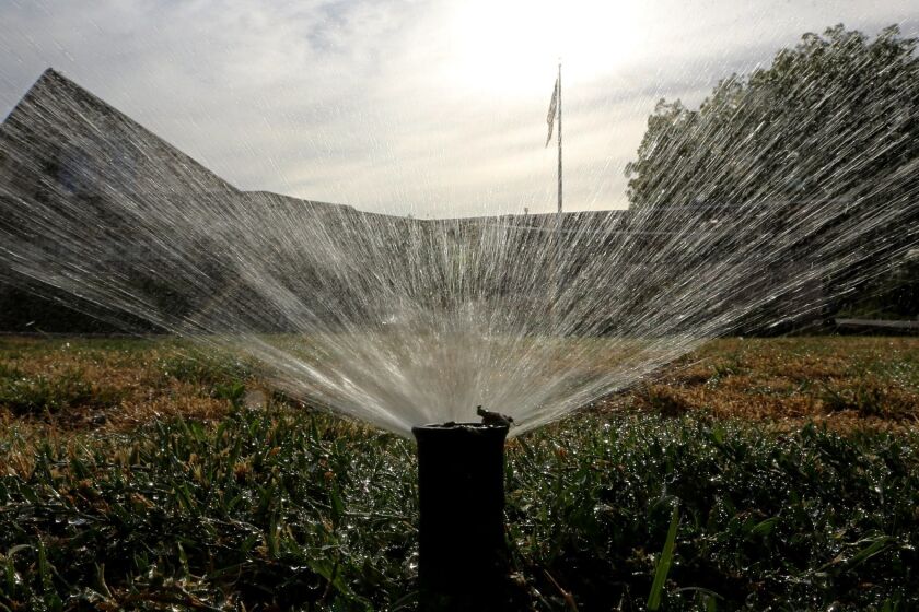 FILE - In this July 15, 2014, file photo, sprinklers water a lawn in Sacramento, Calif. Most Californians have heard by now that they should stop watering their lawns to save water in the drought. But there are smaller steps to take, too, from taking shorter showers and doing less laundry to restaurants skipping water at tables. (AP Photo/Rich Pedroncelli, File)