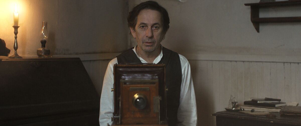 A man poses behind a camera in the movie "White on White."