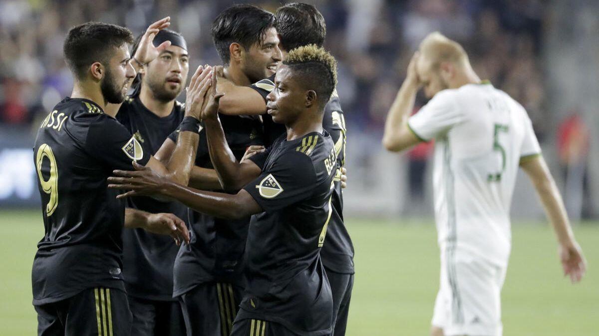 LAFC players celebrate a goal by forward Marco Urena against the Portland Timbers during the first half of a match on July 18.