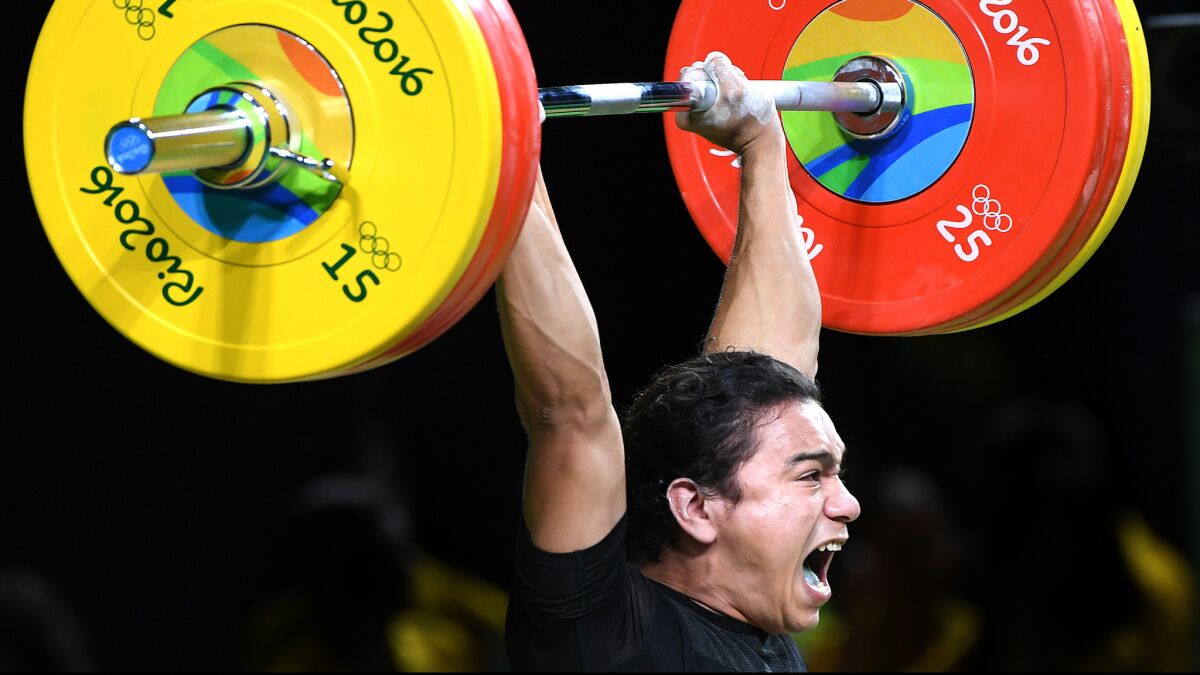 El Salvador's Julio Cesar Salamanca Pineda makes a successful lift during qualifying in the men's 62-kilogram competition.