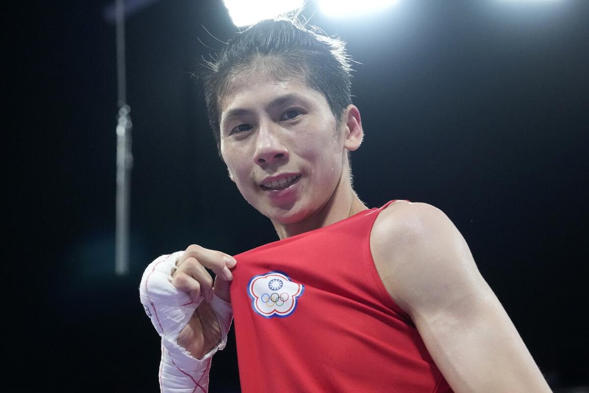 Taiwan's Lin Yu Ting celebrates after defeating Bulgaria's Svetlana Staneva.