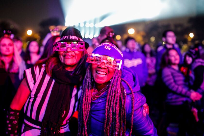 LOS ANGELES, CALIF. -- SUNDAY, DECEMBER 31, 2017: Maria De Leon, from left, and Debra Randall, celebrate New Years Eve at Grand Park in Los Angeles, Calif., on Dec. 31, 2017. (Marcus Yam / Los Angeles Times)