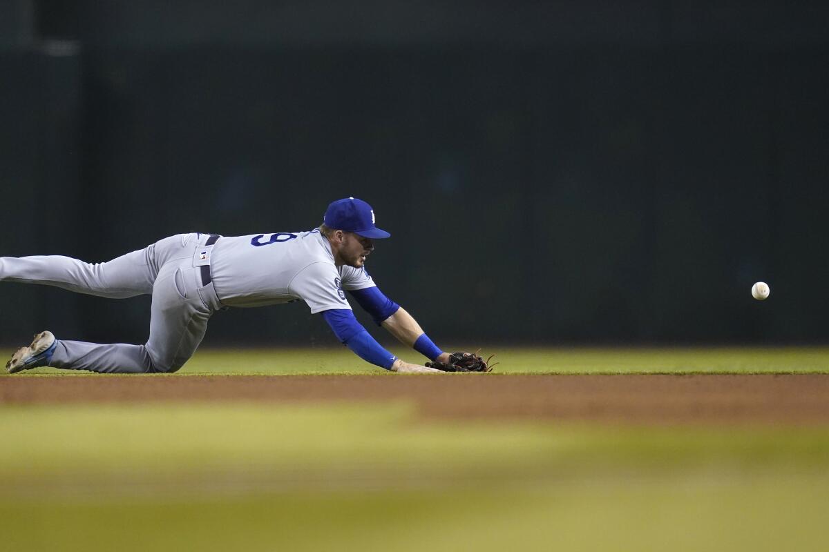 Dodgers shortstop Gavin Lux is unable to make a play on a single hit by Arizona's David Peralta.