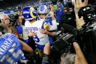 Rams quarterback Matthew Stafford hugs Lions quarterback Jared Goff after Goff led Detroit to a playoff win