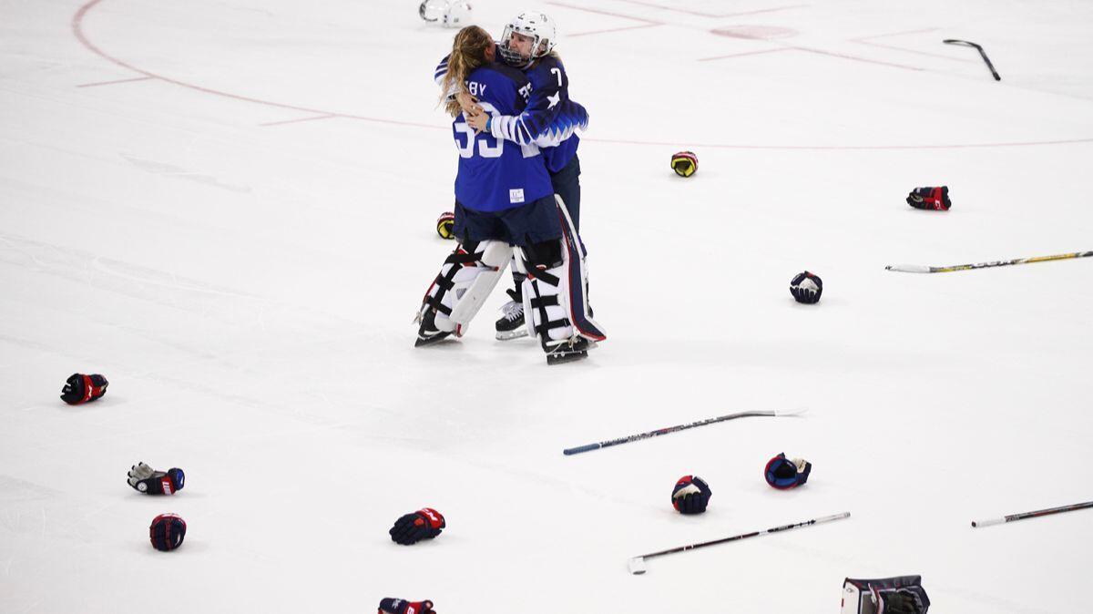 U.S. women's hockey's Alex Rigsby, left, and Monique Lamoureux-Morando celebrate after winning the women's gold medal hockey game against Canada at the 2018 Winter Olympics on Thursday.