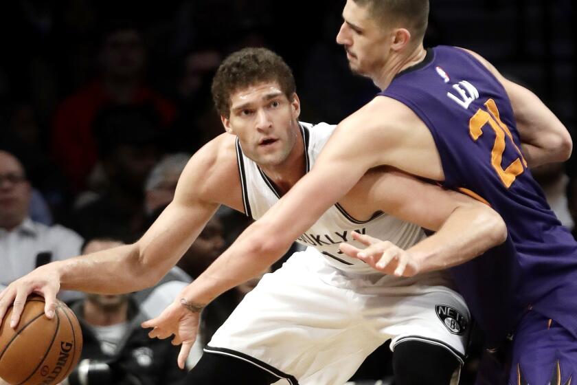Nets center protects the ball from Suns center Alex Len while working in the post during the second half Thursday night.