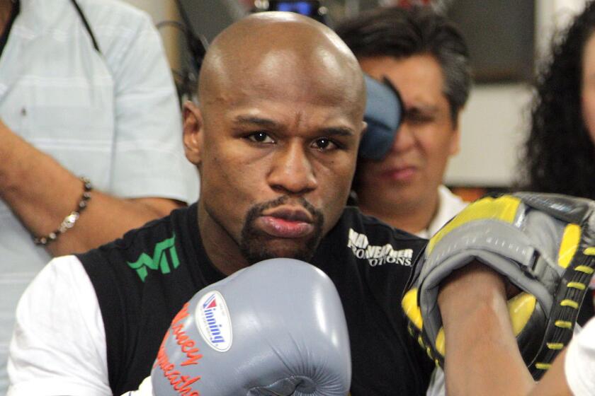 Welterweight champion Floyd Mayweather Jr. works out at Mayweather Boxing Club in Las Vegas on April 14 as he trains for his May 2 title fight against Manny Pacquiao.