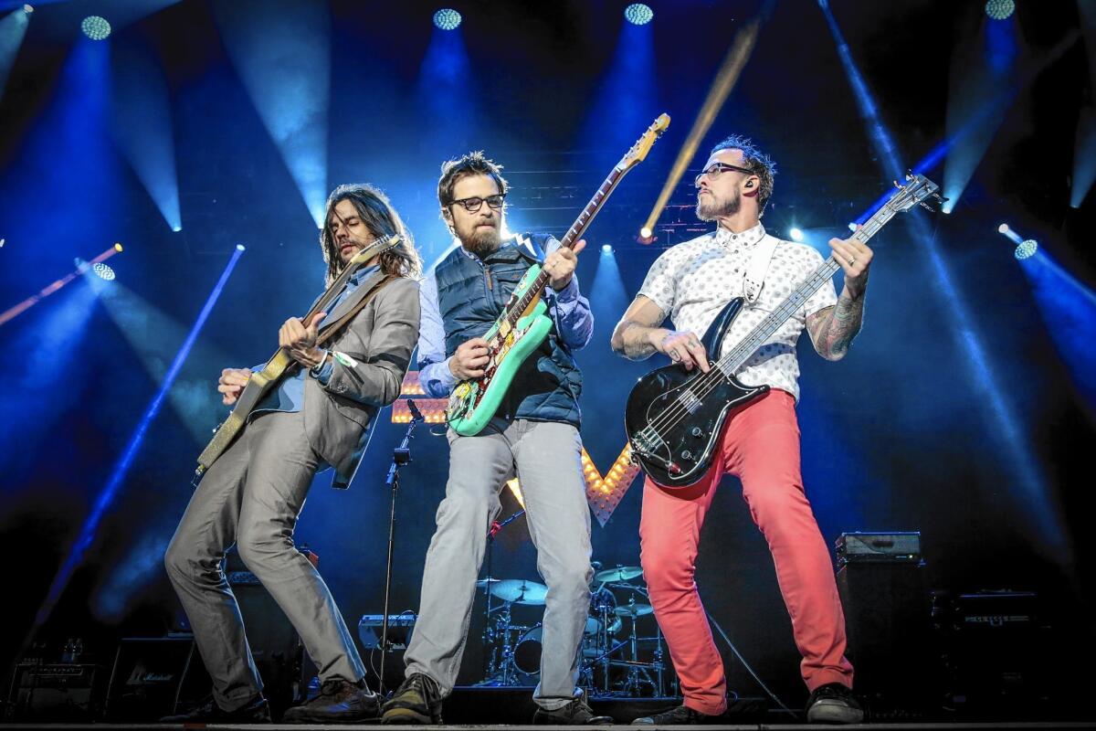 Brian Bell, left, Rivers Cuomo and Scott Shriner of Weezer perform on Day 2 of the Osheaga Music and Art Festival on Aug. 1, 2015, in Montreal.