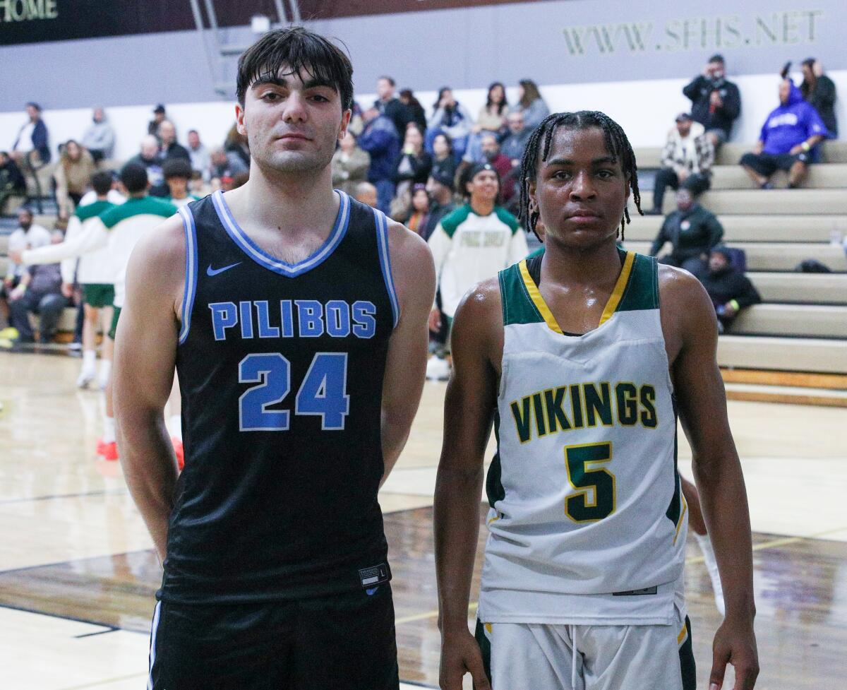 Junior guard Anto Balian of Pilibos and sophomore guard Timmy Anderson of Blair stand together on a court.
