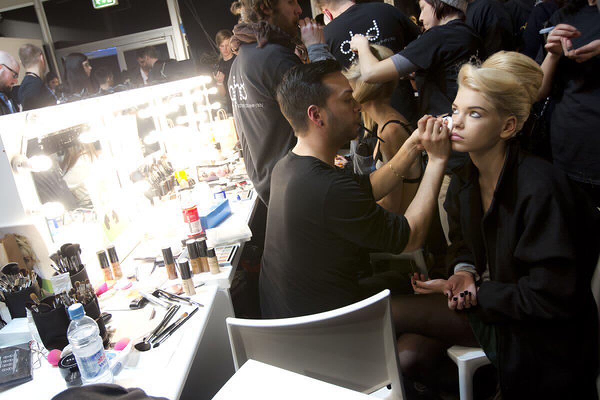 A model has makeup applied backstage during London Fashion Week. Cosmetics tested on animals are now banned in the European Union.