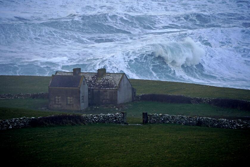 Waves crashing against the shore at Doolin in County Clare on the west coast of Ireland, Sunday, Feb. 20, 2022. (Niall Carson/PA via AP)